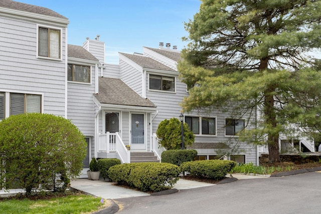 201 Rowayton Woods Dr Unit 201, Norwalk, CT 06854 - view of front of home featuring a chimney and roof with shingles