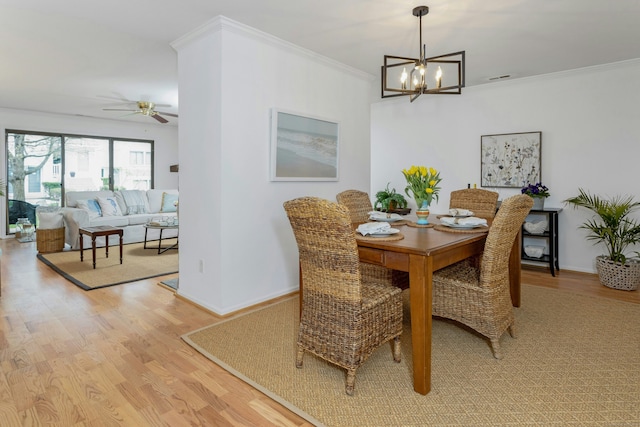 201 Rowayton Woods Dr Unit 201, Norwalk, CT 06854 - dining area with light wood-type flooring, baseboards, crown molding, and ceiling fan with notable chandelier
