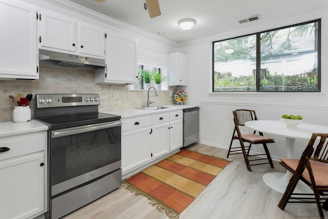 201 Rowayton Woods Dr Unit 201, Norwalk, CT 06854 - kitchen featuring a sink, stainless steel appliances, light countertops, under cabinet range hood, and visible vents