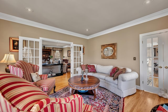 living area with ornamental molding, french doors, recessed lighting, and wood finished floors