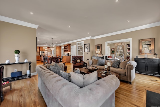 living room with recessed lighting, ornamental molding, and light wood-style flooring