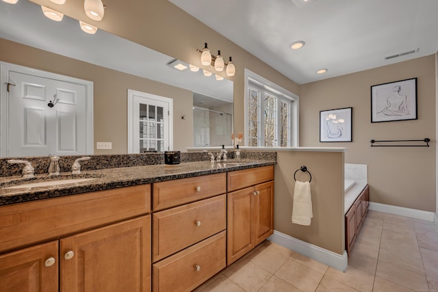 full bathroom featuring baseboards, a sink, a stall shower, and tile patterned flooring