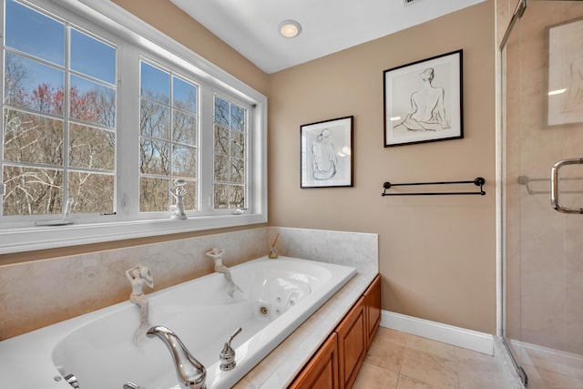 bathroom featuring a jetted tub, tile patterned floors, baseboards, and a stall shower