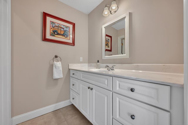 bathroom with tile patterned floors, baseboards, and vanity