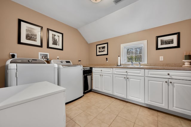 washroom with laundry area, visible vents, washing machine and clothes dryer, a sink, and light tile patterned flooring