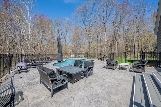 view of patio / terrace featuring a grill, outdoor lounge area, a fenced backyard, and a fenced in pool