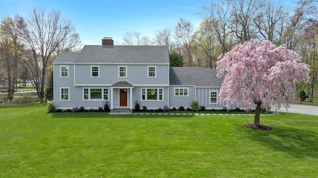 4 Rabbit Ln, Darien, CT 06820 - view of front of house with a front yard, roof with shingles, and a chimney