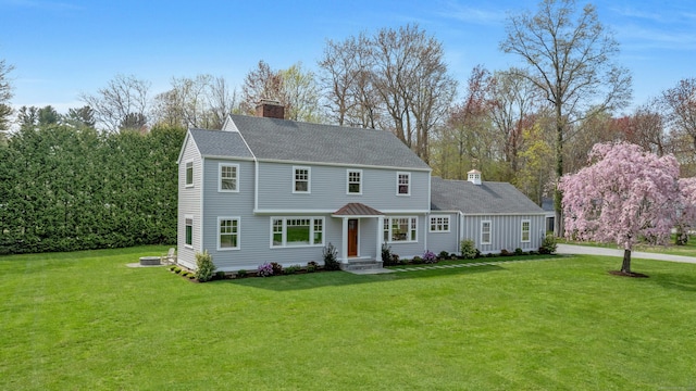 4 Rabbit Ln, Darien, CT 06820 - view of front facade with a chimney, roof with shingles, and a front yard