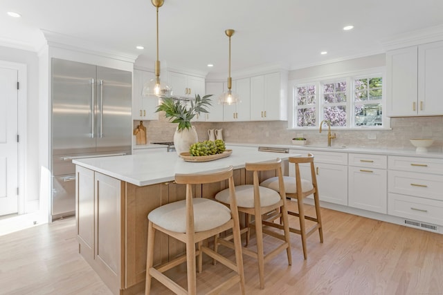 4 Rabbit Ln, Darien, CT 06820 - kitchen featuring light countertops, a sink, crown molding, built in fridge, and light wood-style flooring