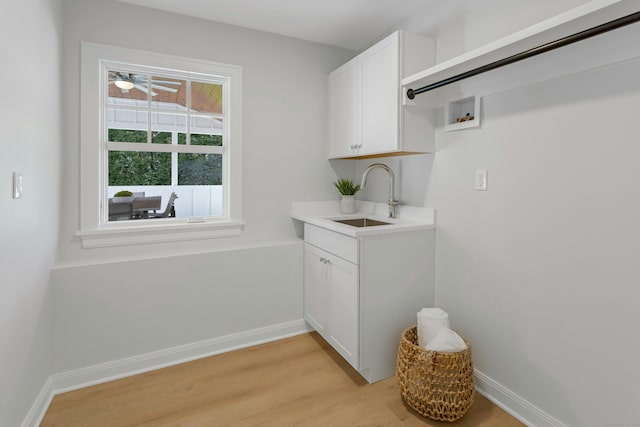 4 Rabbit Ln, Darien, CT 06820 - clothes washing area featuring light wood finished floors, hookup for a washing machine, baseboards, and a sink