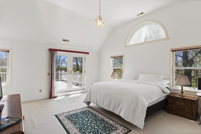 bedroom featuring access to exterior, visible vents, lofted ceiling, an inviting chandelier, and carpet