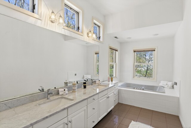 full bath with a sink, tile patterned flooring, and a healthy amount of sunlight