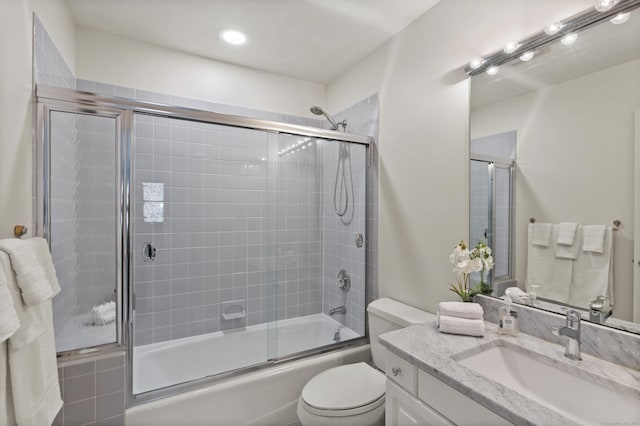 full bathroom featuring vanity, recessed lighting, toilet, and shower / bath combination with glass door