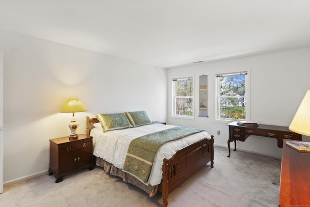 bedroom featuring baseboards and light carpet
