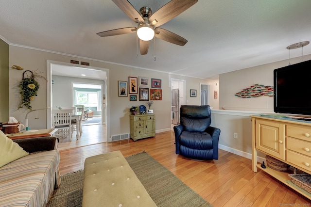 531 Oxbow Dr, Torrington, CT 06790 - living area featuring a ceiling fan, light wood-type flooring, ornamental molding, and baseboards