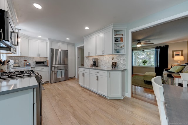 531 Oxbow Dr, Torrington, CT 06790 - kitchen with appliances with stainless steel finishes, ceiling fan, white cabinets, tasteful backsplash, and light wood-style floors