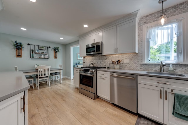 531 Oxbow Dr, Torrington, CT 06790 - kitchen featuring appliances with stainless steel finishes, a sink, backsplash, decorative light fixtures, and recessed lighting