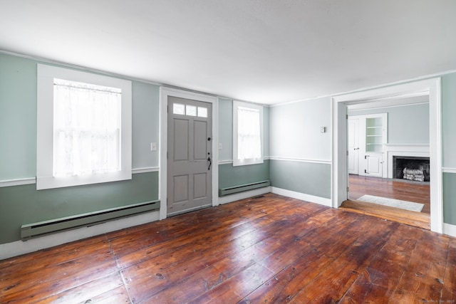 foyer featuring a fireplace with flush hearth, baseboards, wood-type flooring, and a baseboard heating unit