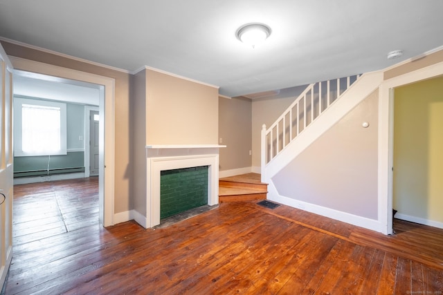 unfurnished living room featuring crown molding, wood-type flooring, stairs, baseboards, and a baseboard radiator