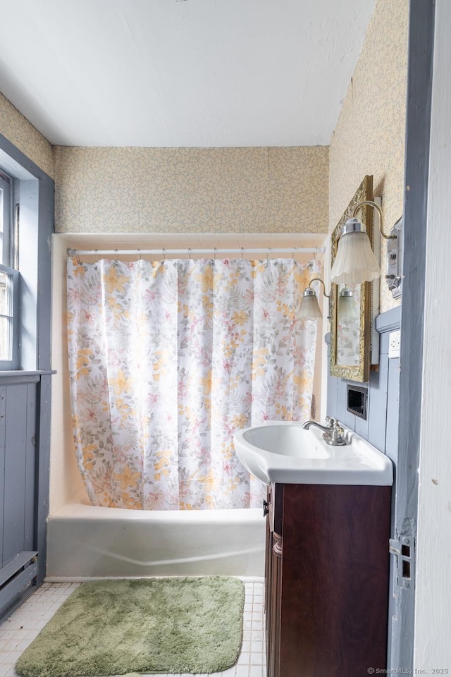 bathroom featuring wallpapered walls, a baseboard radiator, shower / tub combo with curtain, and vanity