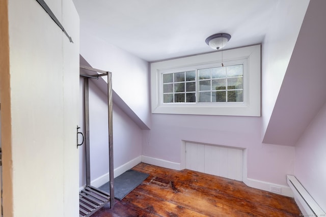 interior space with a baseboard heating unit and hardwood / wood-style flooring