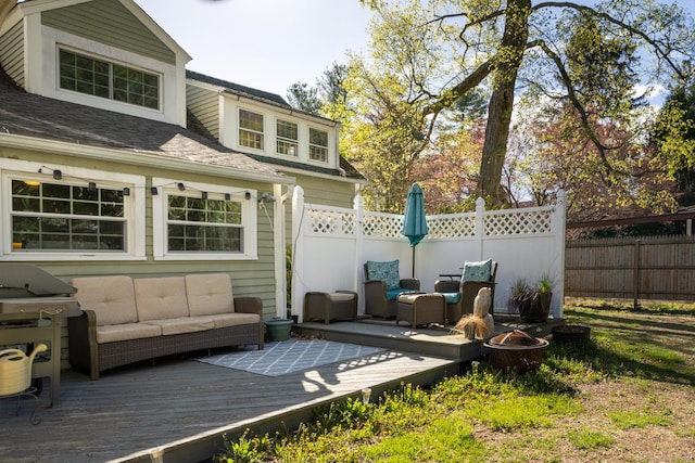 exterior space featuring fence, a wooden deck, a shingled roof, and outdoor lounge area