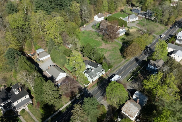 drone / aerial view with a residential view and a view of trees