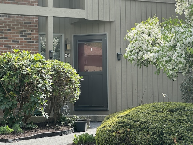 doorway to property with brick siding