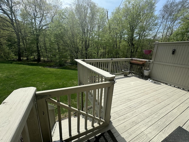 wooden terrace with a lawn