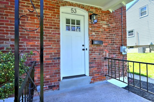 53 Bina Ave, Windsor, CT 06095 - doorway to property featuring brick siding and central air condition unit