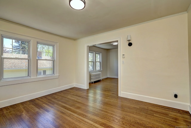 53 Bina Ave, Windsor, CT 06095 - unfurnished room featuring radiator heating unit, baseboards, wood finished floors, and ornamental molding