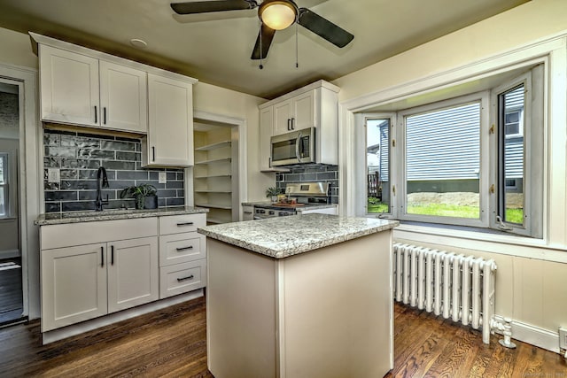 53 Bina Ave, Windsor, CT 06095 - kitchen featuring stainless steel appliances, radiator heating unit, a sink, and backsplash