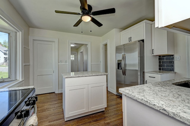 53 Bina Ave, Windsor, CT 06095 - kitchen featuring stainless steel fridge, plenty of natural light, dark wood-style floors, and white cabinets