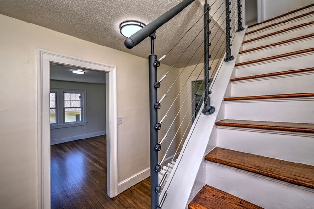 53 Bina Ave, Windsor, CT 06095 - stairs with wood finished floors, baseboards, and a textured ceiling