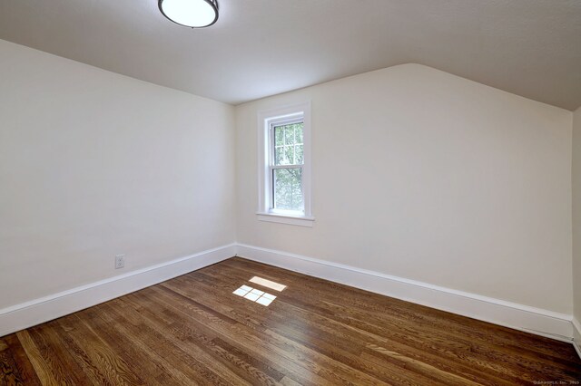 53 Bina Ave, Windsor, CT 06095 - empty room with dark wood finished floors, baseboards, and vaulted ceiling