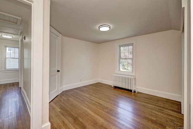 53 Bina Ave, Windsor, CT 06095 - spare room with radiator heating unit, dark wood-style flooring, baseboards, and attic access