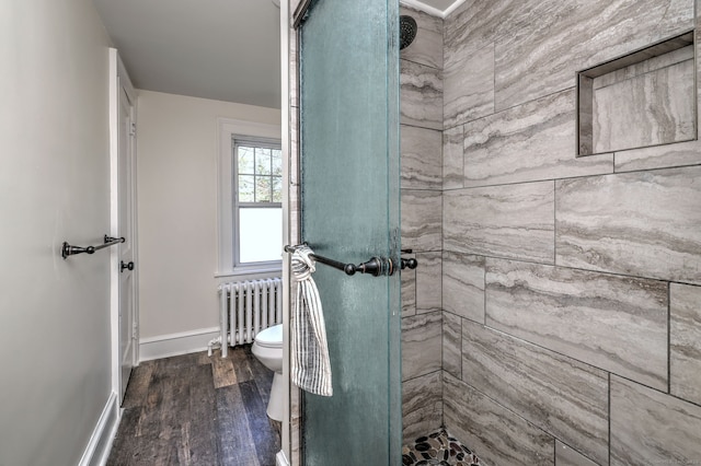 53 Bina Ave, Windsor, CT 06095 - full bathroom with radiator heating unit, a stall shower, wood finished floors, and toilet