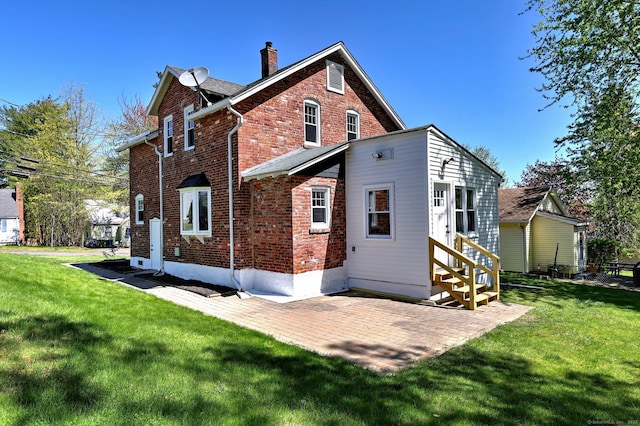 53 Bina Ave, Windsor, CT 06095 - rear view of property featuring a chimney, brick siding, entry steps, and a lawn