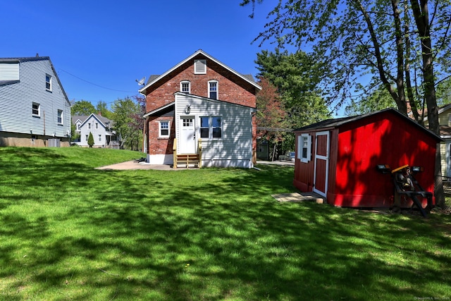 53 Bina Ave, Windsor, CT 06095 - rear view of property with entry steps, a shed, a yard, and an outbuilding