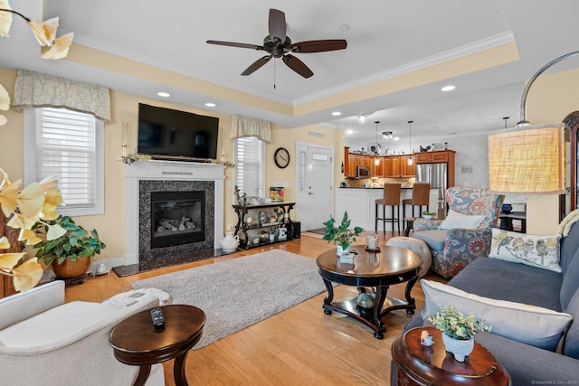 95 S Ridge Ln Unit G103, Berlin, CT 06037 - living room featuring a tray ceiling, light wood-style floors, crown molding, and a ceiling fan