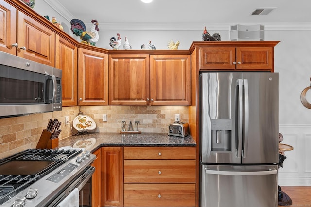 95 S Ridge Ln Unit G103, Berlin, CT 06037 - kitchen featuring brown cabinets, backsplash, ornamental molding, and stainless steel appliances
