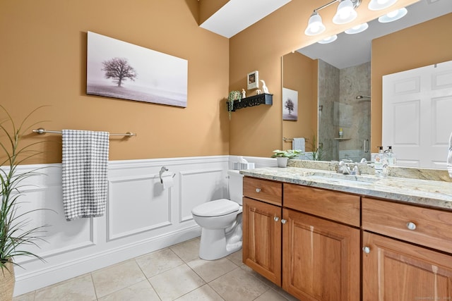 95 S Ridge Ln Unit G103, Berlin, CT 06037 - bathroom with a tile shower, tile patterned floors, a wainscoted wall, toilet, and vanity
