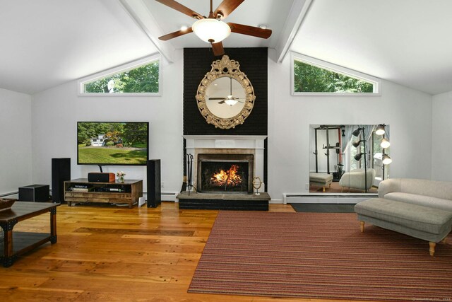 8 Oak Ln, Weston, CT 06883 - living room with beam ceiling, wood finished floors, ceiling fan, a fireplace, and a baseboard radiator