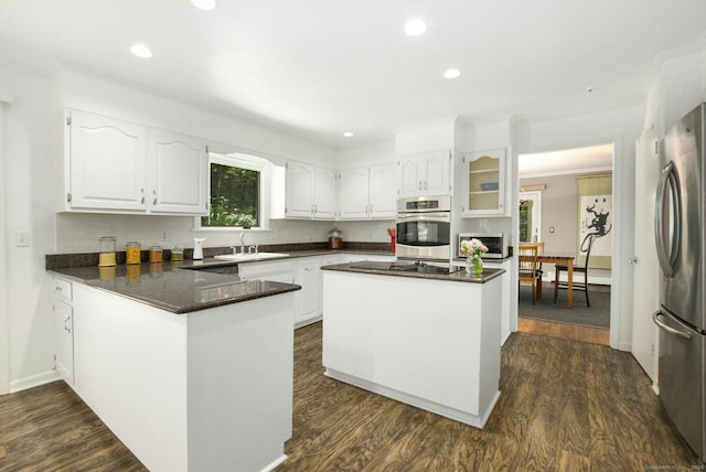 8 Oak Ln, Weston, CT 06883 - kitchen featuring white cabinets, a peninsula, appliances with stainless steel finishes, and a sink