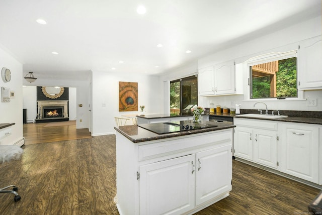 8 Oak Ln, Weston, CT 06883 - kitchen with black electric cooktop, a sink, a kitchen island, and dark wood finished floors