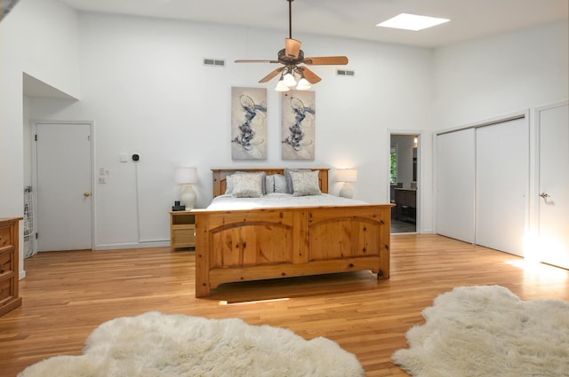 8 Oak Ln, Weston, CT 06883 - bedroom with light wood-type flooring, visible vents, and high vaulted ceiling