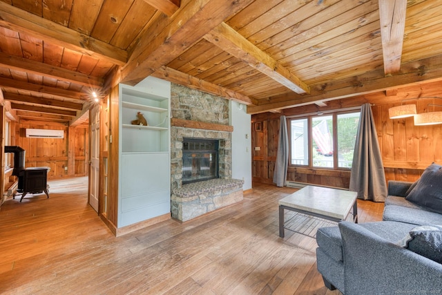 615 Jackson St, Thomaston, CT 06787 - living room with a wooden ceiling with exposed beams, wood-type flooring, wood walls, a wall mounted AC, and a wood stove