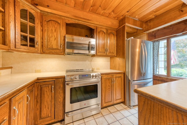 615 Jackson St, Thomaston, CT 06787 - kitchen featuring stainless steel appliances, brown cabinets, wood ceiling, light tile patterned floors, and light countertops