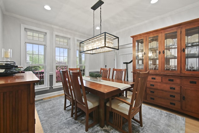 dining area featuring a chandelier, ornamental molding, light wood-type flooring, and recessed lighting
