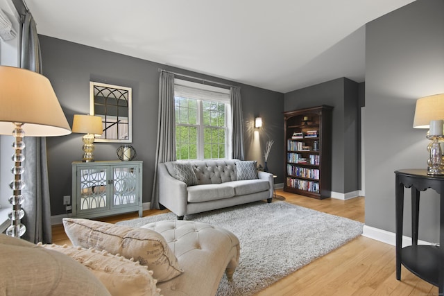 living room featuring wood finished floors and baseboards